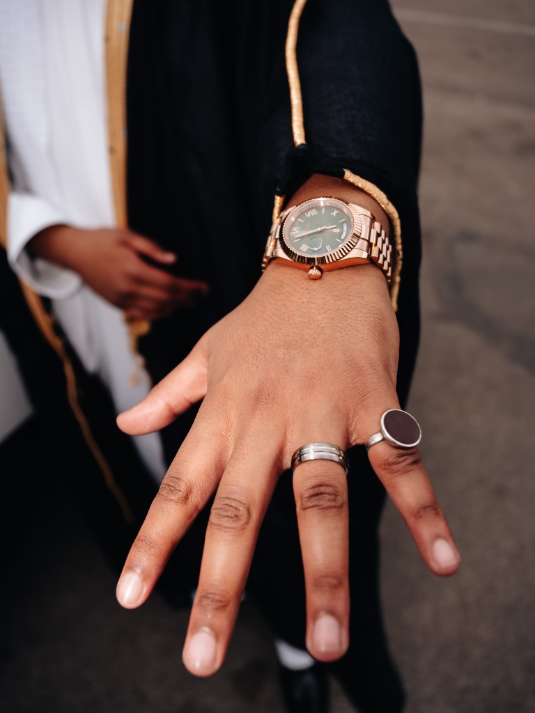 Close-up Portrait of Rolex Watch and Rings